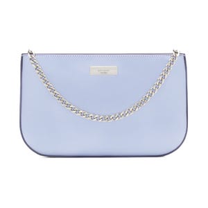 A light blue handbag featuring a silver chain strap and a metal logo plaque on the front.