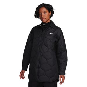 A black, quilted Nike trench coat with a button-up front, featuring a subtle Nike logo on the chest. The coat has a collar and long sleeves, with a textured, wavy quilt pattern.