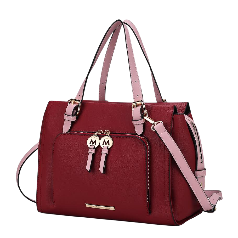 A red handbag with pink straps, featuring gold-tone hardware and a front zip pocket with two round charms marked \“M\“.