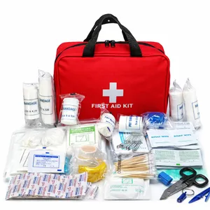 A red first aid kit contains bandages, gauze, scissors, safety pins, wipes, gloves, tape, cotton swabs, and assorted medical supplies.