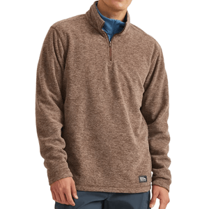 A brown quarter-zip pullover sweater worn over a blue shirt, featuring long sleeves and a small branded tag near the hem.