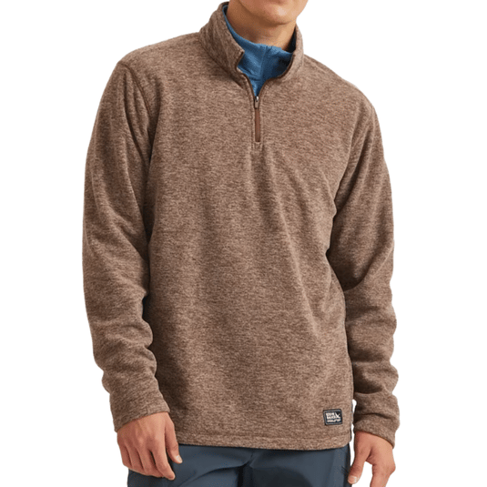 A brown quarter-zip pullover sweater worn over a blue shirt, featuring long sleeves and a small branded tag near the hem.