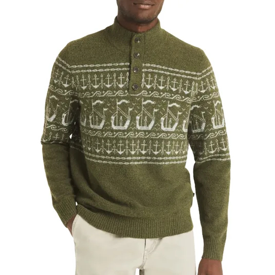 Olive green sweater with a Nordic-inspired pattern featuring ships and anchors, a button-up collar, ribbed cuffs, and hem paired with light beige pants.