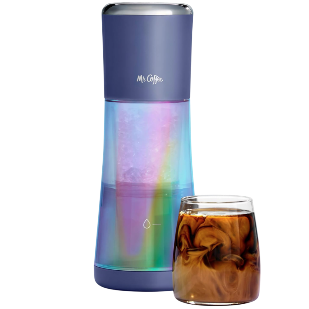 A Mr. Coffee iced coffee maker with a colorful, translucent design sits beside a glass of swirled iced coffee.