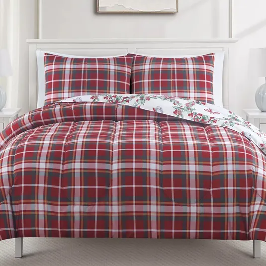 A red plaid bedding set with matching pillowcases is shown, featuring a reversible design with a festive winter-themed pattern on the reverse side.