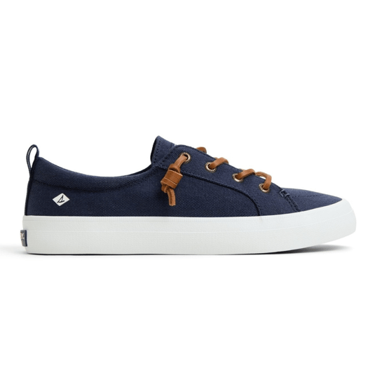 A navy canvas sneaker with white soles, featuring brown leather laces and a small logo on the side.