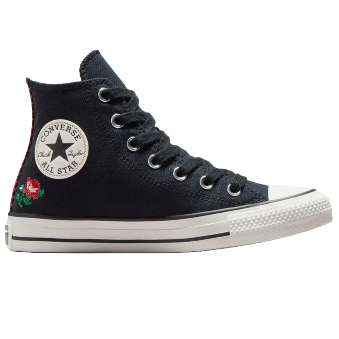 A black high-top Converse Chuck Taylor All Star shoe with embroidered red flowers and the classic logo on the side.