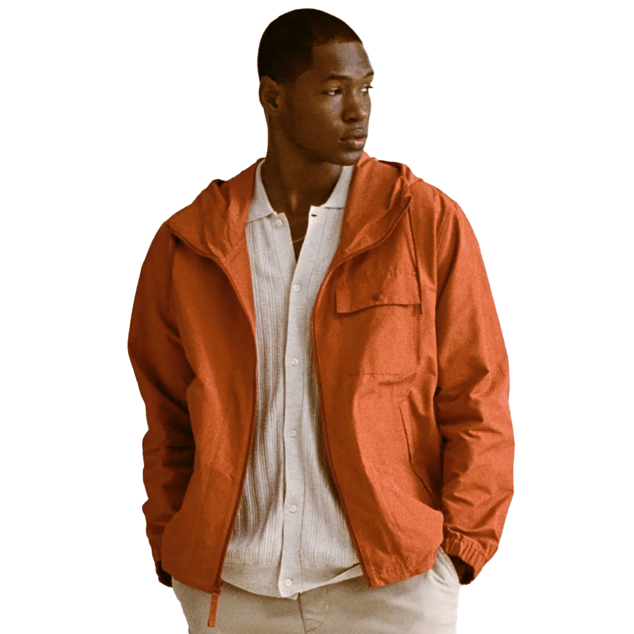 A man wearing a brick red jacket over a beige button-up shirt.