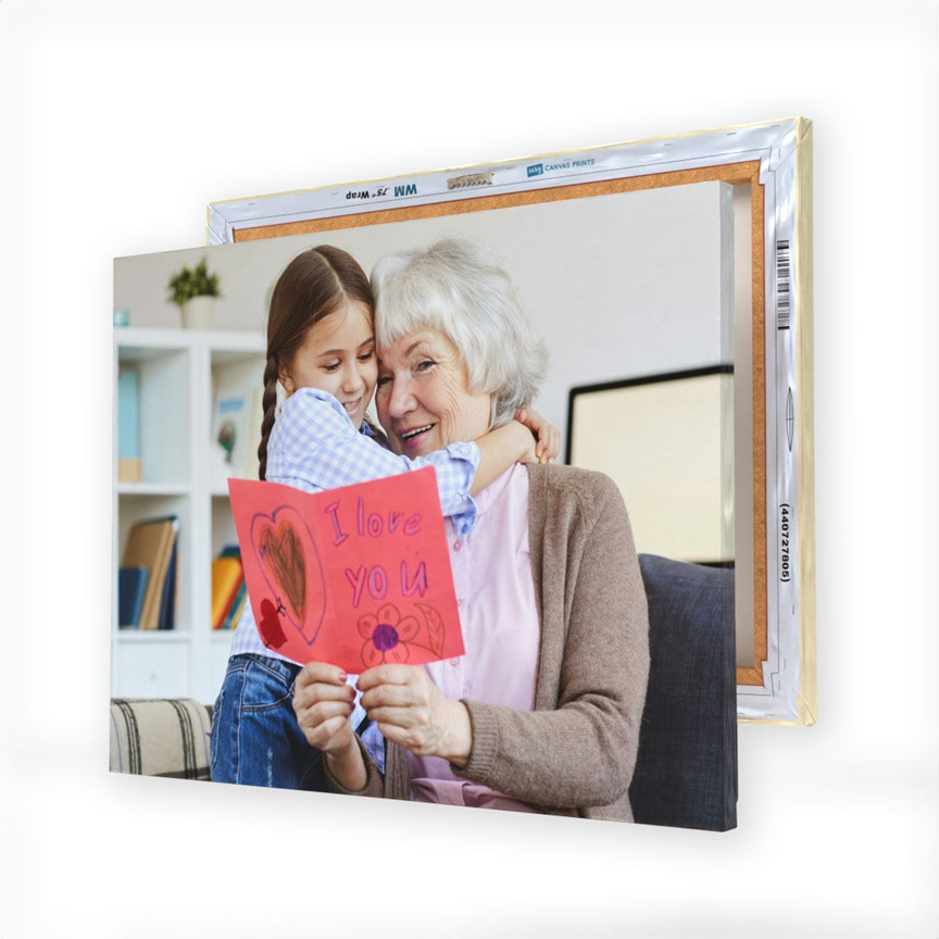 A canvas print displays a touching image of a young girl hugging an elderly woman while holding a handmade card that reads \“I love you.\“