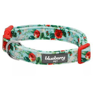 A floral patterned dog collar with a light blue background, red flowers, and green leaves, featuring a red plastic buckle and a metal D-ring. The label reads \“blueberry PET.\“