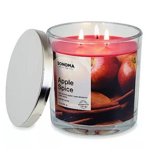 Sonoma Goods for Life Apple Spice Candle with three wicks, featuring red wax, a metallic lid, and a label depicting apples and cinnamon sticks.
