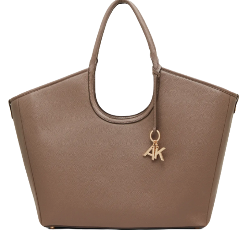 A taupe tote bag with a rounded top handle and gold \“AK\“ charm detail.