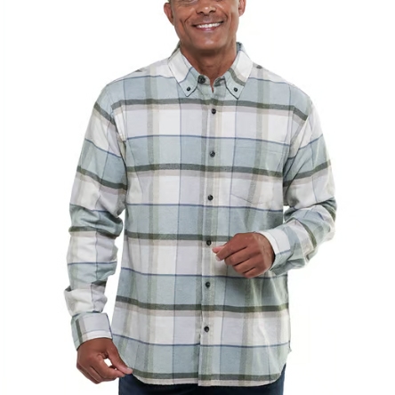 A man is wearing a button-up long-sleeve plaid shirt in tones of gray, white, and blue, featuring a front pocket and buttoned collar.