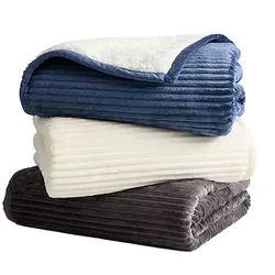A stack of folded, ribbed fleece blankets in blue, cream, and gray colors, showcasing their plush texture and cozy design.