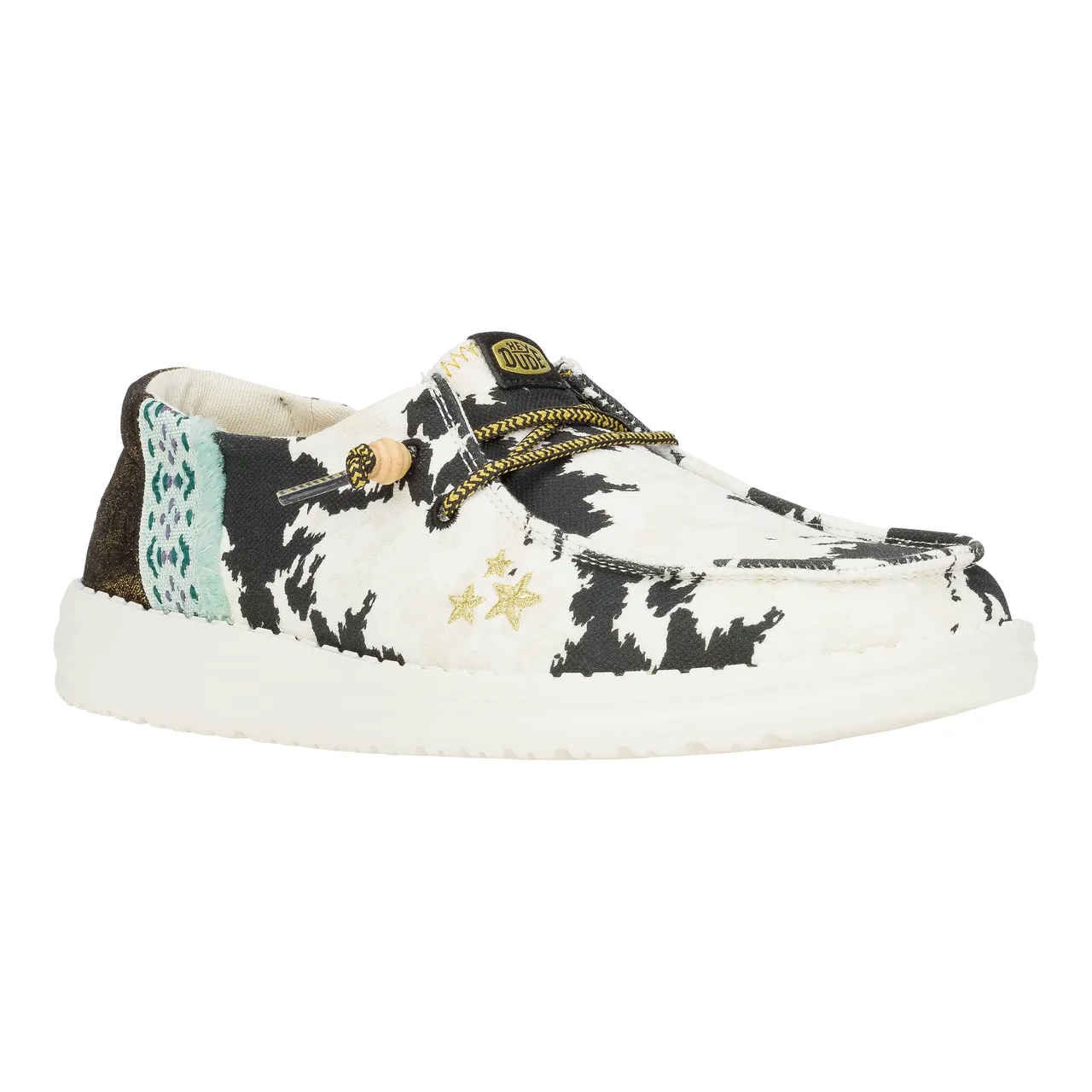Hey Dude Wendy Disco Cow Shoes feature a black and white cow print design with a touch of turquoise and gold star accents. They have a comfortable slip-on style with a lightweight, cushioned sole.