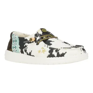 Hey Dude Wendy Disco Cow Shoes feature a black and white cow print design with a touch of turquoise and gold star accents. They have a comfortable slip-on style with a lightweight, cushioned sole.