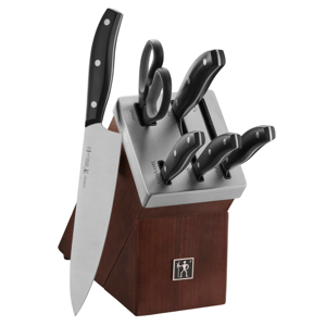 A knife set with a wooden block includes various knives and kitchen shears, each slot labeled for its specific type: chef's, utility, paring knife, and shears.