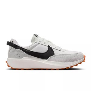 White and gray sneaker with a black swoosh and orange sole, featuring a modern retro design.