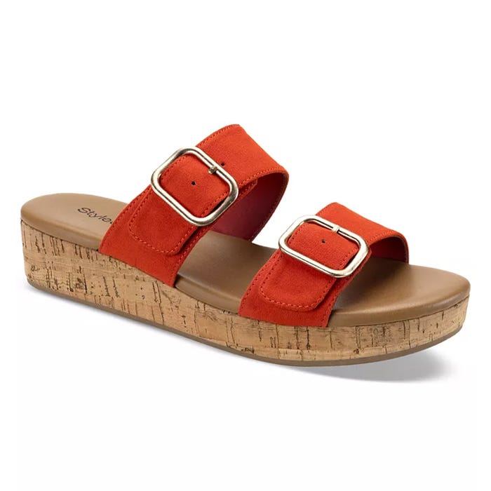 A pair of red slide sandals with two buckled straps and a cork-style sole.