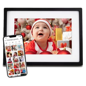 A Skylight Digital Photo Frame displaying a holiday-themed image of a baby in red and white attire, accompanied by a smartphone app interface showing various photos. The frame has a black border and is designed for easy digital photo sharing and display.