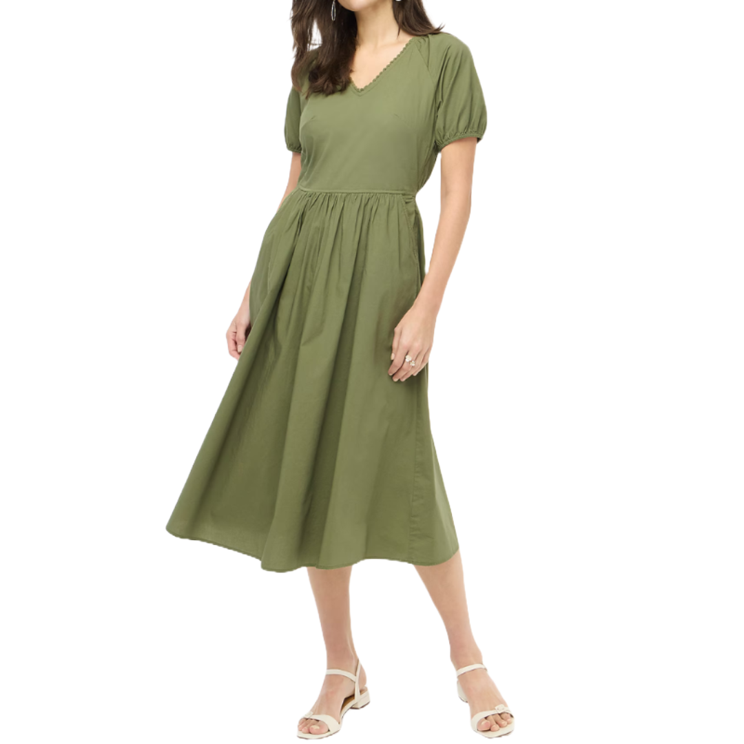 Olive green midi dress with lace trim, short puff sleeves, and a V-neckline. Features a fitted waist and a flowy skirt, paired with white strappy sandals.