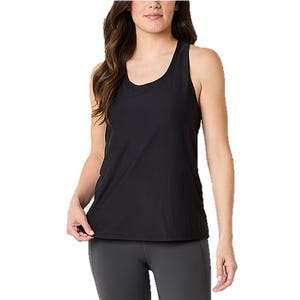 A woman is wearing a black sleeveless tank top paired with dark leggings.