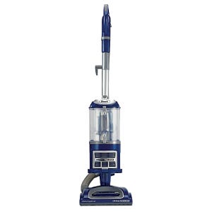 A Shark Navigator upright vacuum cleaner with a transparent dust cup and a blue and silver color scheme.