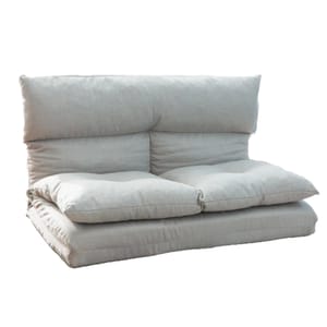An adjustable flip floor sofa with plush cushions and a soft, neutral fabric. It can be configured for seating or lounging, offering versatility for different comfort needs.