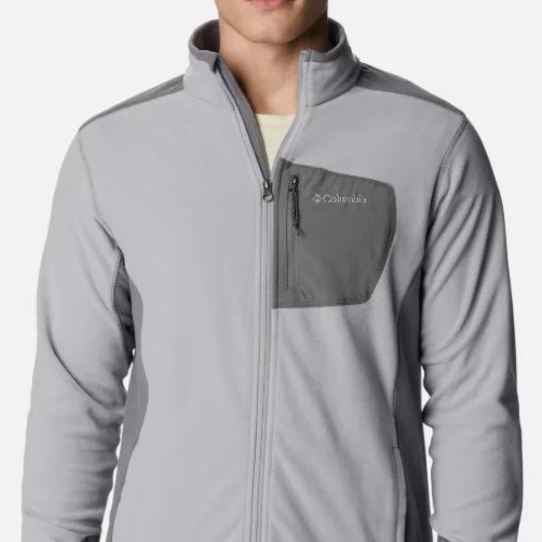 A person is wearing a light gray Columbia fleece jacket with a full-length zipper and a chest pocket.