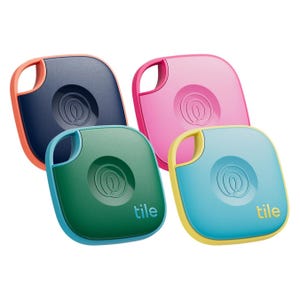 Four colorful Tile Bluetooth trackers, used for locating lost items, are shown: one in blue, one in pink, one in green, and one in navy.