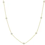 Gold chain necklace featuring evenly spaced small round diamond or cubic zirconia stones set in bezels.
