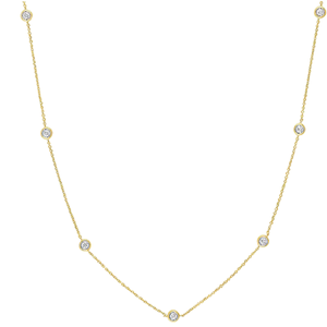 Gold chain necklace featuring evenly spaced small round diamond or cubic zirconia stones set in bezels.