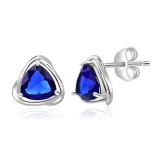 Silver stud earrings with triangular lab-created sapphire stones, featuring a polished silver setting and post backs.