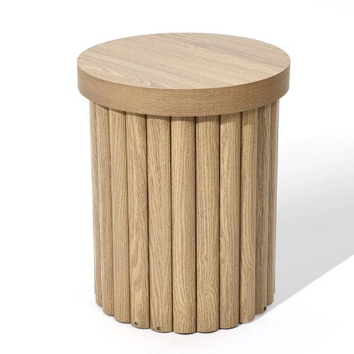 A round wooden side table features a cylindrical base with vertical slats and a smooth top surface.