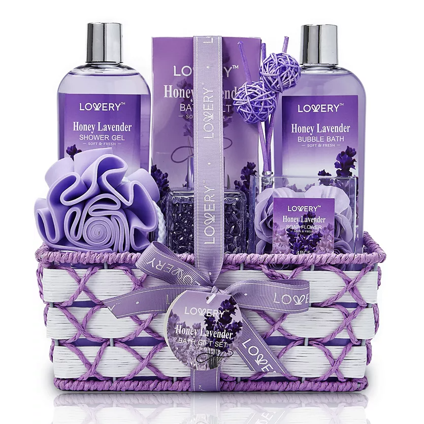 Gift set featuring Honey Lavender scented items: shower gel, bath salts, bubble bath, soap flowers, and a bath sponge, all arranged in a woven basket.