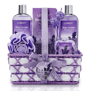 Gift set featuring Honey Lavender scented items: shower gel, bath salts, bubble bath, soap flowers, and a bath sponge, all arranged in a woven basket.