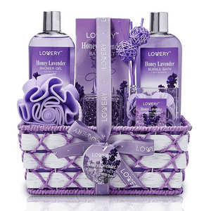 Gift set featuring Honey Lavender scented items: shower gel, bath salts, bubble bath, soap flowers, and a bath sponge, all arranged in a woven basket.