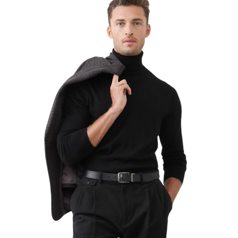 A man is wearing a black turtleneck and matching trousers with a belt, holding a jacket over his shoulder.