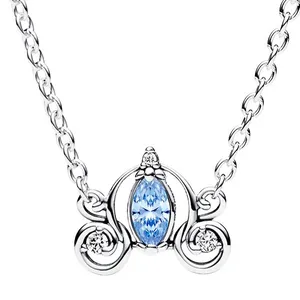 A necklace with a silver chain features an ornate pendant resembling a carriage, with a central marquise-cut light blue gemstone and small accent stones.