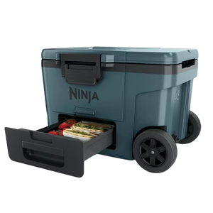 A wheeled cooler with a pull-out drawer labeled \“Ninja,\“ designed for portable food and drink storage.