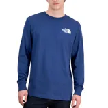 A person wears a blue long-sleeve The North Face t-shirt with a small white logo on the chest, paired with dark jeans.