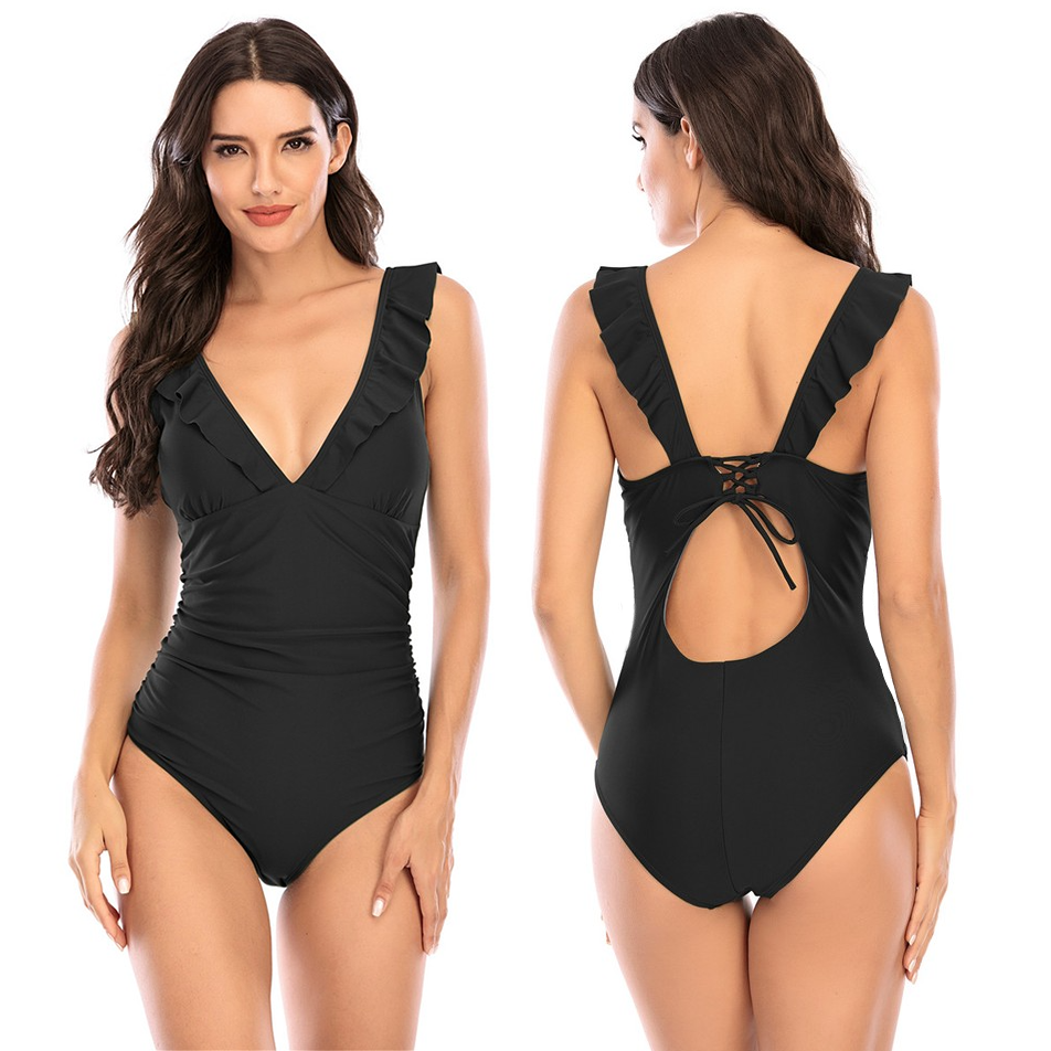 A black one-piece swimsuit with ruffle details and a lace-up back.