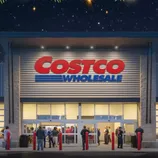 A Costco store entrance is decorated with holiday lights and pine branches, with people visible inside and outside.