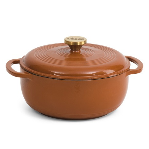 A round, brown enameled cast iron Dutch oven with a lid and side handles, featuring a gold knob on top.