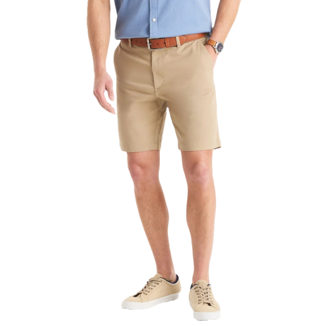 Khaki stretch deck shorts paired with a brown belt and blue shirt. Featuring a tailored fit, they're complemented by beige sneakers with white soles, offering a casual and polished look.