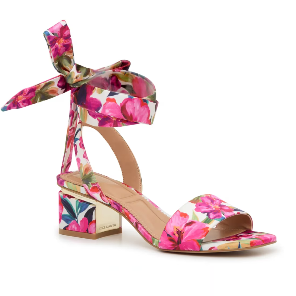 A floral-print sandal with an open toe, low block heel, and ankle strap featuring a bow detail.