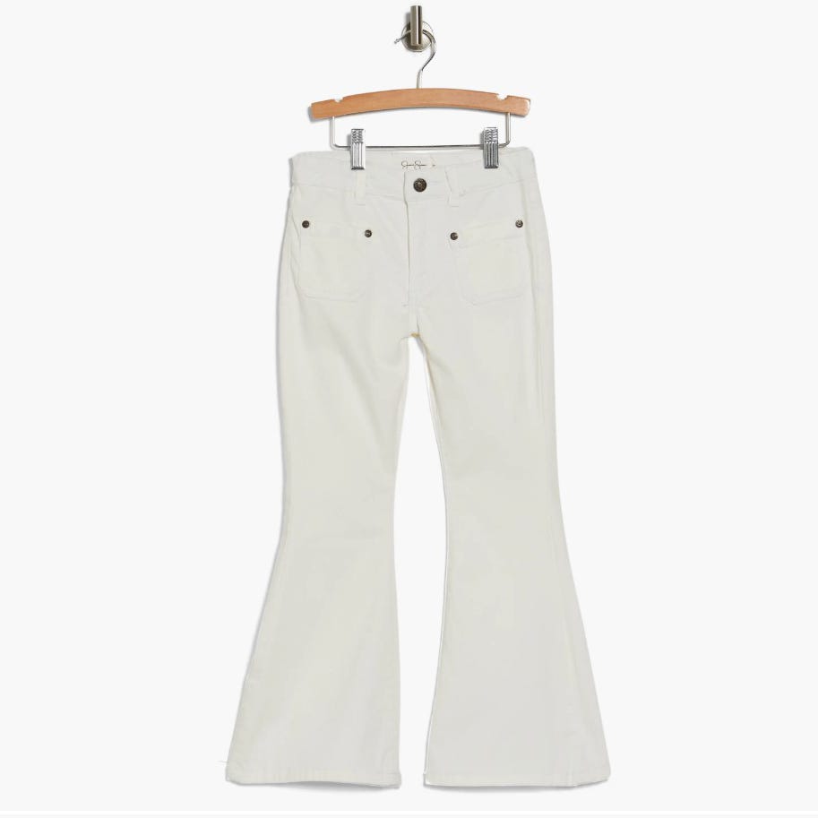 A pair of white flared jeans displayed on a wooden hanger.