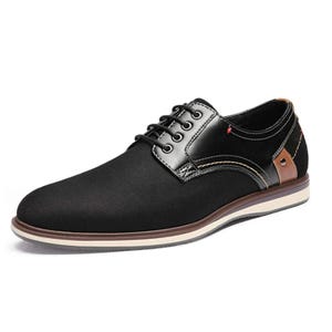 A black men's dress shoe with lace-up closure and contrasting brown detail.