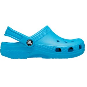 A bright blue Crocs clog with a strap around the heel, featuring ventilation holes and a logo button on the side.