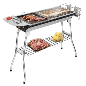 A foldable charcoal BBQ grill with a cooking grate, a small side table with utensils and sauce, a small rack holding seasonings, and a lower shelf storing trays of raw meat and corn. The grill includes both a grilling surface and a flat-top griddle.